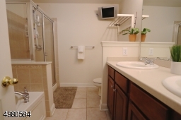 A spacious en-suite is complete with a double vanity, jetted tub and stall shower.