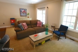 Sun shines through large windows, making your time in the living room peaceful and relaxing.