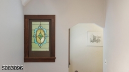 Archways & stained glass windows add to the charm of this beautiful home
