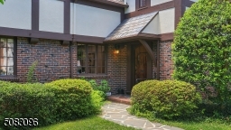 Gorgeous brick and Arched oak entry door with wrought iron details.