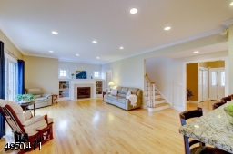 Spacious Room - Highlighted by a Heatilator direct-vent Fireplace tastefully done with wood mantel, attractive marble hearth & surround; flanked by custom built shelving & cabinetry.