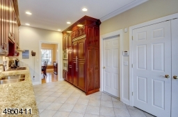 Easy access to the oversized attached garage.  French doors open to the laundry area.  Porcelain floor, granite counter top and breakfast bar.