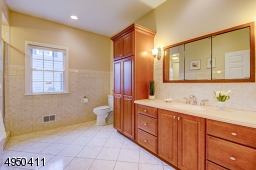 Convenient and attractively done with porcelain floor, large shower, vanity w/Corian counter, built-in cabinet.
