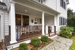 Rocking chair friendly front porch!  Very warm & welcoming with mahogany floor and railings.