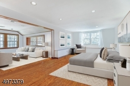 This en-suite bedroom for guests has a large sitting area that overlooks the vaulted ceiling in the Sunroom.  There is also a private staircase from the Sunroom just for this en-suite bedroom. Virtually Staged.