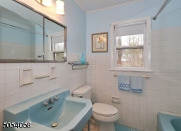 Tiled full bathroom with tub &  shower.