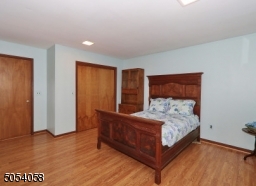 Bedroom located on first floor with view of th pool.