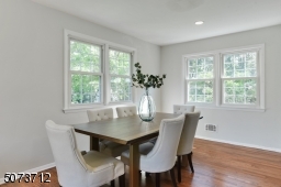 Recessed lights on dimmer, wood flooring.