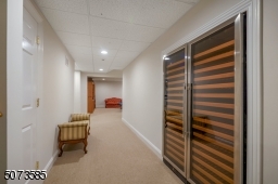 Finished basement with two built-in wine fridges, bedroom, and full bath.