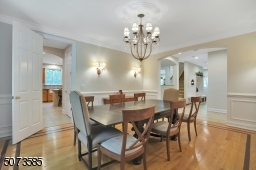 Enjoy entertaining in the large dining room with wainscoting and custom wood floors.