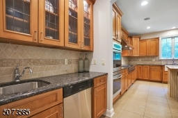 This house has everything! Even a wet bar with a second dishwasher located between the dining room and kitchen and across from the WALK-IN PANTRY.