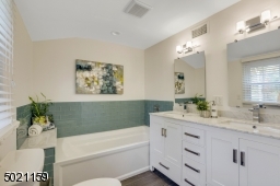 Indulge in the luxurious feeling of bathing in this spa-like bathtub and walk-in shower.  Double sinks, wood vanity and beautiful marble & tiles add to your soothing private escape!