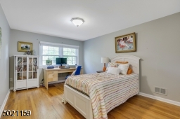 Spacious bedroom features hardwood floors, natural light, great closet space & access to ample attic storage.