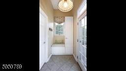 Mud room with built-in cabinetry & window seat offers plenty of storage and a place to hang your coats, backpacks, etc.