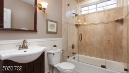 Beautifully remodeled with transom window, seamless glass door tub enclosure, beautiful tiles and fixtures