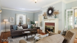 Parquet Wood Floors with Mahogany ribbon inlay, Wood burning Fireplace, French Doors to Family Room, Brass fixtures, and high ceilings