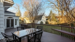For your outdoor dining pleasure overlooking a beautiful yard, this deck offers built-in seating and plenty of room for your outdoor furniture as well.