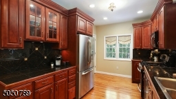 Gorgeous wood cabinetry, stainless steel appliances recessed lights & hardwood floors
