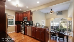 Meal prep made easy in this working kitchen with gorgeous granite counters & backsplash, undermount cabinet lighting, pantry closet and double stainless steel sink overlooking Breakfast Room,