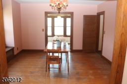 Generously-sized Dining Room; features hardwood floor, chandelier, large window w/ window seat
