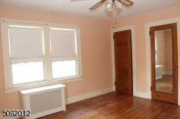 Another viiew of MBR; 2 closets; hardwood floors; ceiling fan