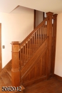 Staircase to second floor; beautiful original woodwork