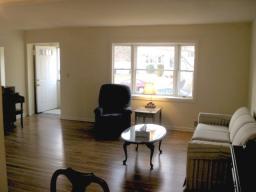 Living Room with Gleaming hardwood Floors & Picture Window ~