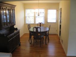 Dining Room with Gleaming Hardwood floors, Door Leads to Lovely Yard with Patio ~