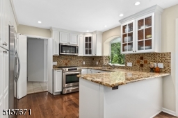 Under cabinet lighting,, Breakfast Bar, double stainless steel sink with an architectural window, crown moldings, double glass sliders to the rear deck and an eat-in area