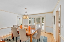 French doors from the dining room lead to the large paver patio & serene park-like property