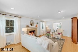 A stunning wood burning fireplace is the focal point of this large front to back living room