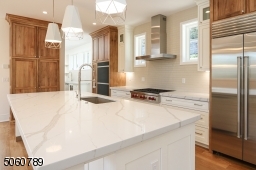 Top-of-the-line stainless appliances, Polarstone Calacatta Manhattan Quartz Countertops, Pinoak Woodworks Cabinetry + Pantry