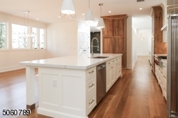 Designer Kitchen with Wolf Oven & Cooktop, Sub-Zero Refrigerator, Cove Dishwasher, Polarstone Calacatta Manhattan Quartz Countertops, Pinoak Woodworks Cabinetry + Pantry