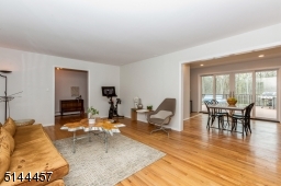 Living room opens to  a formal dining room wood floors recessed lights