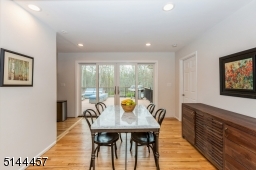 Enjoy the seasonal views from dining room which has 2 glass panels and sliding door leading to an AZEK deck Dining room opens to family room and kitchen