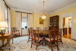 This view is from the French doors in the foyer looking into the large square room.  Seller has chosen a round table, perfect for dinner parties.