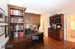 Current residents needed a fine office and installed impressive built ins.  Not needed?  This room can be restored to a bedroom with attached bath and walk in closet.  Note hardwood floors.