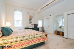 Spacious 17x15 top floor bedroom has 14' ceiling and two double closets