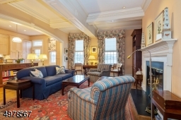 Move from the foyer into the open concept Great Room / Kitchen.  Coffered ceiling, elegant archway fefine the spaces.  Wood burning fireplace is flanked by built in bookcases.  Prefer a gas fireplace?  Gas plumbing is present for easy conversion.
