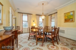 View is from the Great Room into the dining room shown to highlight the number of windows.  Note deep crown and base moldings and hardwood floor