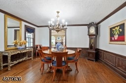 spacious formal dining room with crown molding, wood floor
