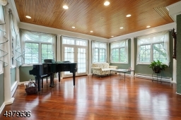 sun-lit & windowed, hardwood floors, french doors lead to the bridal staircase, patio to side yard