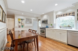 wood cabinets, SS appliances, wood floors, leads to the laundry room, mud room and over-sized 2 car garage