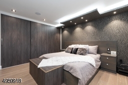 with dropped ceiling , recess lights, large custom closet and build in speakers