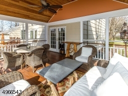 An inviting porch with soaring ceiling & paddle fan