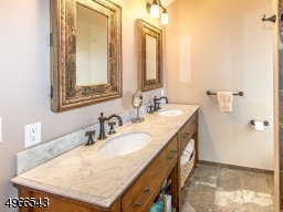 Double sinks, large shower with seamless shower door and custom tiles