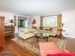 21' living room featuring gleaming hardwood floor & cove molding