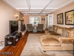 Beamed ceiling, French Doors and woodburning fireplace make this the perfect place to relax