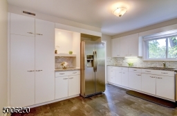 Beautifully remodeled Kitchen in current decor.  Ample cabinets and counter space  -  even a place for your TV!