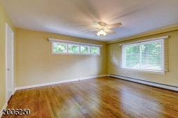 Master Bedroom is spacious.  Features wood floor, newer windows, ceiling fan.